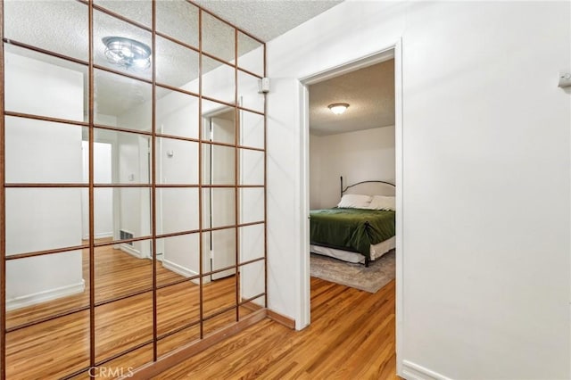16133 Haldane St, Whittier, CA 90603 - hallway with a textured ceiling and wood finished floors