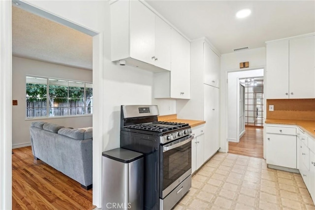 16133 Haldane St, Whittier, CA 90603 - kitchen with stainless steel range with gas stovetop, white cabinetry, light countertops, and light flooring