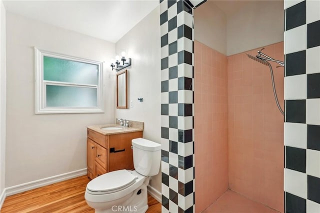 16133 Haldane St, Whittier, CA 90603 - full bath featuring a tile shower, wood finished floors, toilet, and vanity