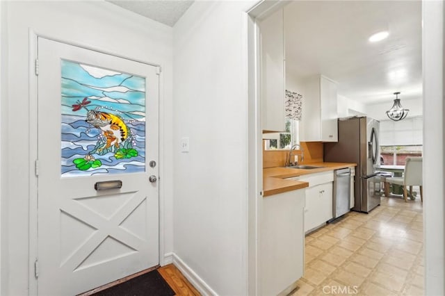 16133 Haldane St, Whittier, CA 90603 - doorway to outside featuring a sink and light flooring