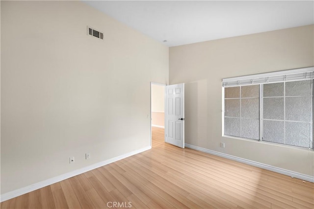 unfurnished room featuring light wood finished floors and baseboards