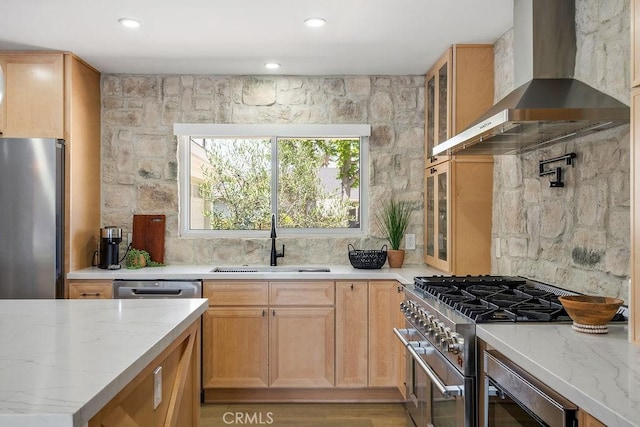 2506 E Roberta Dr, Orange, CA 92869 - kitchen featuring wall chimney exhaust hood, appliances with stainless steel finishes, a sink, light stone countertops, and glass insert cabinets