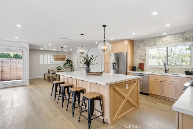 2506 E Roberta Dr, Orange, CA 92869 - kitchen featuring stainless steel appliances, a sink, light brown cabinetry, recessed lighting, and light wood-style flooring