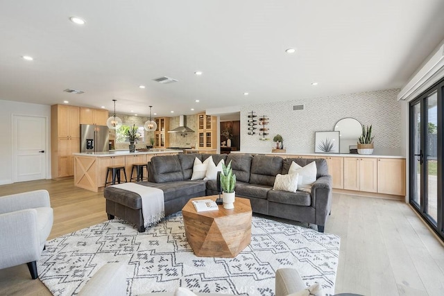 2506 E Roberta Dr, Orange, CA 92869 - living room featuring wallpapered walls, light wood finished floors, and recessed lighting