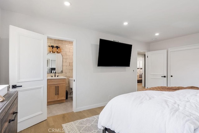 2506 E Roberta Dr, Orange, CA 92869 - bedroom with a sink, light wood-style flooring, recessed lighting, connected bathroom, and baseboards