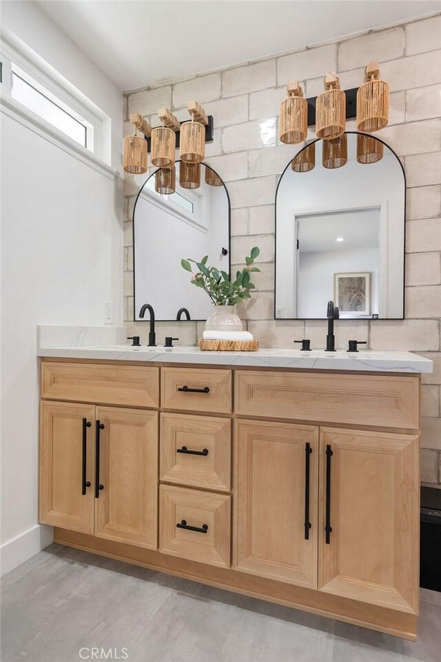 2506 E Roberta Dr, Orange, CA 92869 - bathroom featuring double vanity, a chandelier, and baseboards