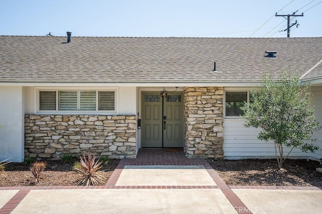 2506 E Roberta Dr, Orange, CA 92869 - view of exterior entry with a shingled roof and stone siding