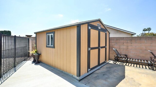 view of shed with a fenced backyard