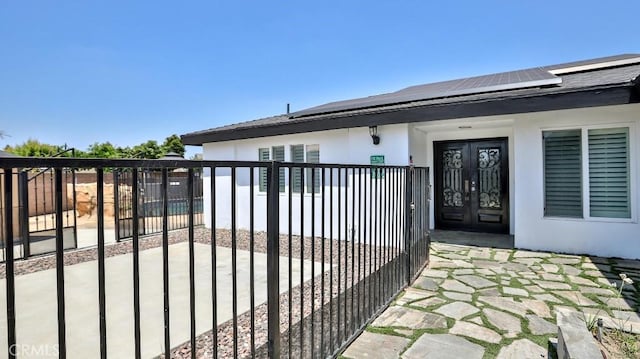 gate featuring french doors and solar panels