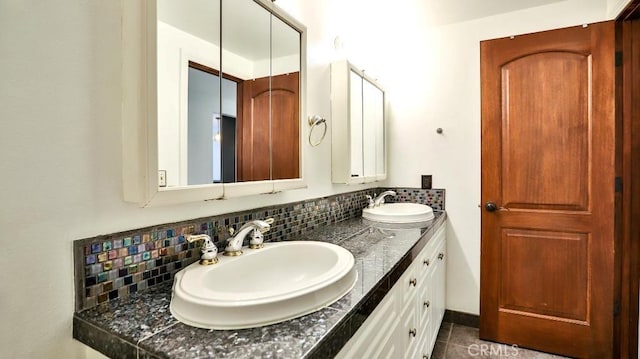 full bath with backsplash, double vanity, and tile patterned flooring
