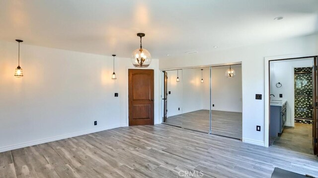 unfurnished bedroom featuring light wood finished floors and baseboards