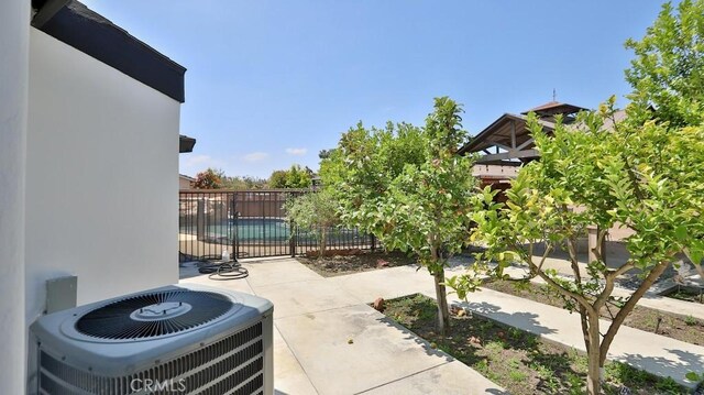 view of patio / terrace with central AC unit and fence