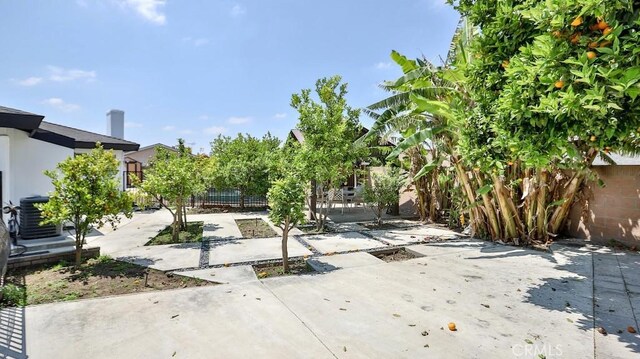 fenced yard with cooling unit and a patio area