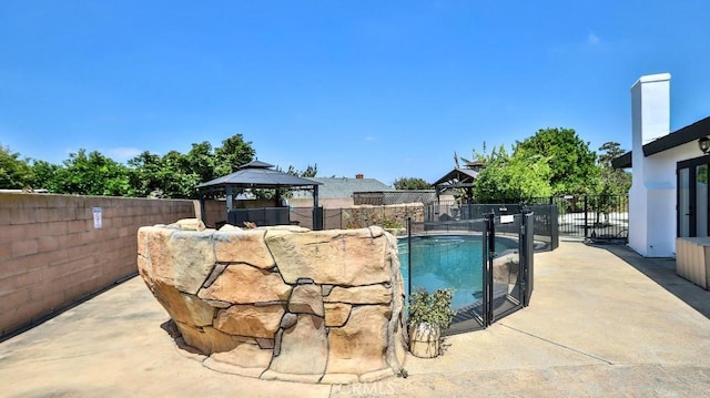 view of pool with a gazebo, a fenced backyard, and a patio area