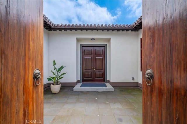 11 Deodar Ln, Bradbury, CA 91008 - view of exterior entry featuring stucco siding and a tile roof