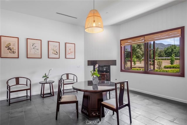 11 Deodar Ln, Bradbury, CA 91008 - dining area with a mountain view, baseboards, and a fireplace