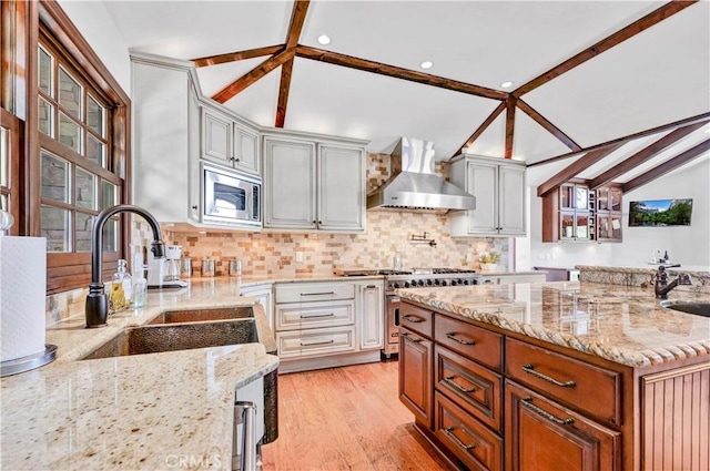4117 Vanetta Pl, Studio City, CA 91604 - kitchen with wall chimney exhaust hood, stainless steel appliances, tasteful backsplash, light stone countertops, and recessed lighting