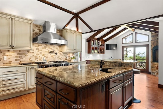 4117 Vanetta Pl, Studio City, CA 91604 - kitchen featuring wall chimney exhaust hood, cream cabinetry, and light stone countertops