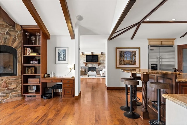4117 Vanetta Pl, Studio City, CA 91604 - office space featuring a stone fireplace, bar, wood finished floors, baseboards, and recessed lighting