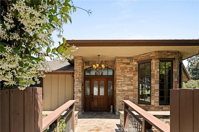 4117 Vanetta Pl, Studio City, CA 91604 - property entrance featuring board and batten siding, stone siding, and a shingled roof