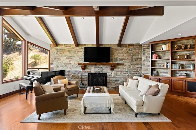 4117 Vanetta Pl, Studio City, CA 91604 - living area with healthy amount of natural light, wood finished floors, and a fireplace