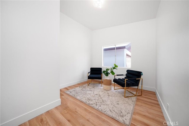 living area with wood finished floors and baseboards