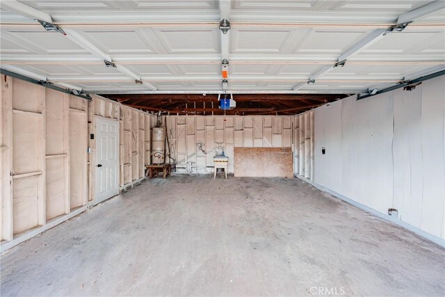 garage with secured water heater and a garage door opener