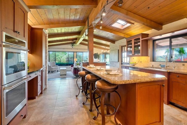 3149 Old Post Rd, Fallbrook, CA 92028 - kitchen with a sink, stainless steel appliances, wooden ceiling, a center island, and backsplash