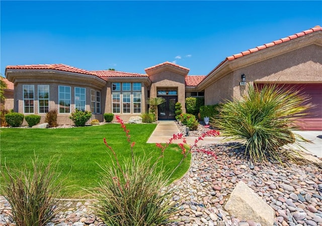 74078 W Petunia Pl, Palm Desert, CA 92211 - rear view of house featuring a tiled roof, an attached garage, stucco siding, and a yard