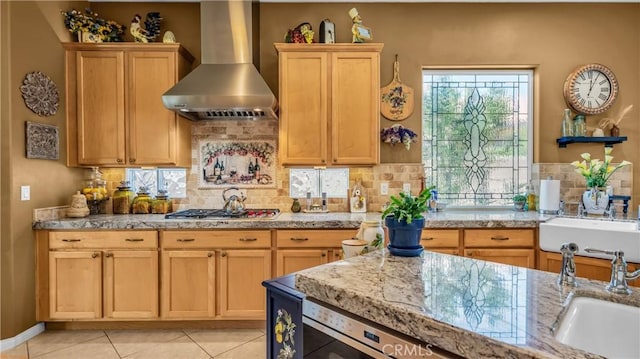 74078 W Petunia Pl, Palm Desert, CA 92211 - kitchen with wall chimney range hood, tasteful backsplash, stainless steel gas cooktop, a sink, and light tile patterned floors