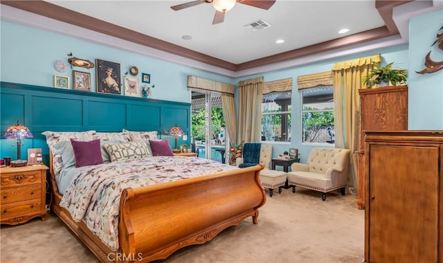 74078 W Petunia Pl, Palm Desert, CA 92211 - bedroom with light colored carpet, a decorative wall, a tray ceiling, ceiling fan, and wainscoting