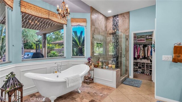 74078 W Petunia Pl, Palm Desert, CA 92211 - full bath with a shower stall, a freestanding tub, a spacious closet, plenty of natural light, and a decorative wall