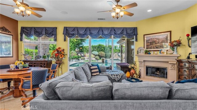74078 W Petunia Pl, Palm Desert, CA 92211 - living room featuring a ceiling fan, a glass covered fireplace, and recessed lighting