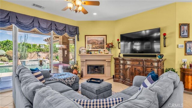 74078 W Petunia Pl, Palm Desert, CA 92211 - living area with a ceiling fan, light tile patterned flooring, a glass covered fireplace, and recessed lighting