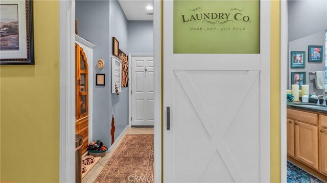 74078 W Petunia Pl, Palm Desert, CA 92211 - hallway with light tile patterned floors and a sink