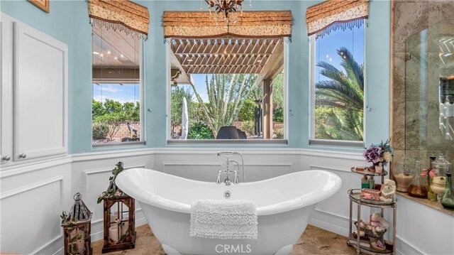 74078 W Petunia Pl, Palm Desert, CA 92211 - bathroom with a decorative wall, a soaking tub, and wainscoting