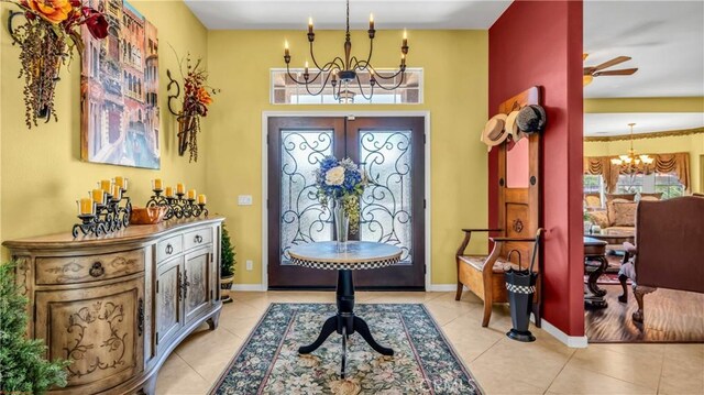 74078 W Petunia Pl, Palm Desert, CA 92211 - foyer entrance featuring a chandelier, light tile patterned flooring, french doors, and baseboards