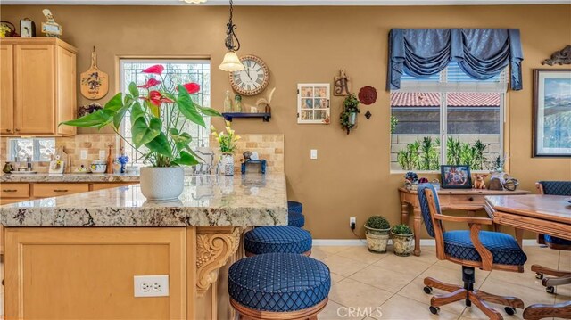 74078 W Petunia Pl, Palm Desert, CA 92211 - kitchen with tasteful backsplash, a peninsula, and healthy amount of natural light