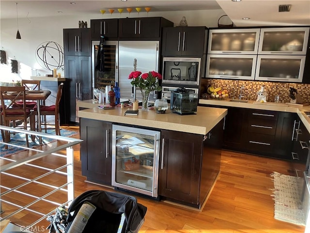 5327 Marina Pacifica Dr N Unit Key19, Long Beach, CA 90803 - bar featuring beverage cooler, built in appliances, backsplash, light wood-type flooring, and recessed lighting