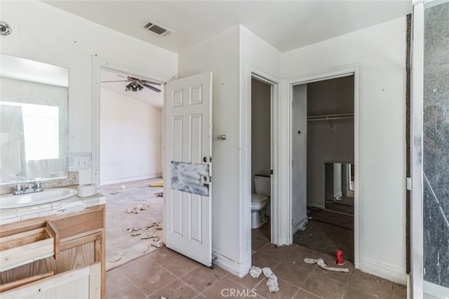8975 Pumalo Rd, Lucerne Valley, CA 92356 - bathroom with toilet, ceiling fan, vanity, and tile patterned floors