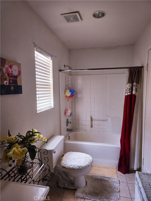 full bathroom featuring tile patterned flooring, shower / tub combo, and toilet