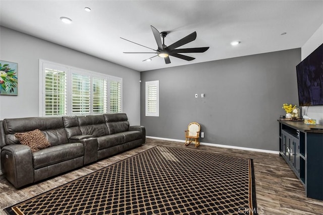 living room featuring dark wood finished floors, a ceiling fan, baseboards, and recessed lighting