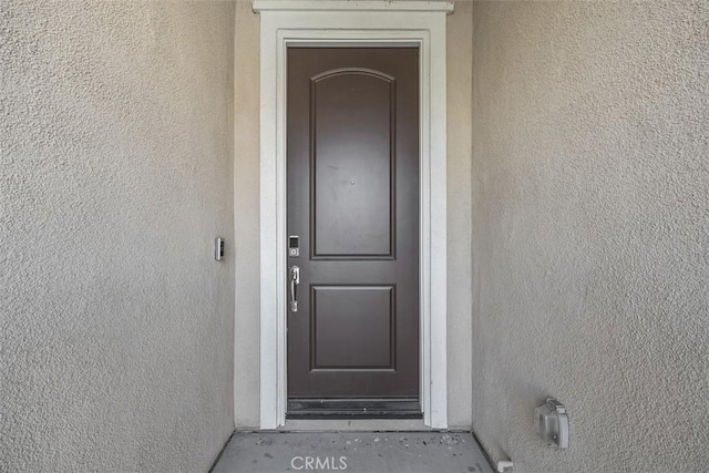entrance to property with stucco siding