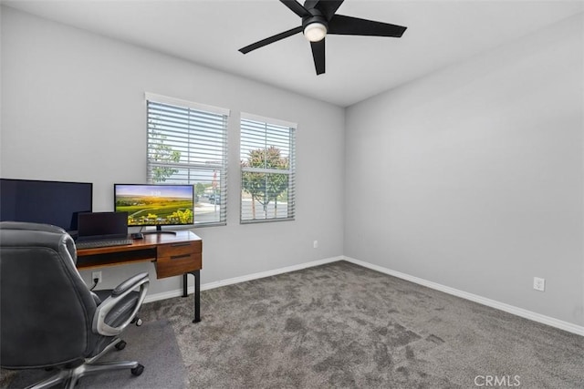 carpeted home office featuring ceiling fan and baseboards