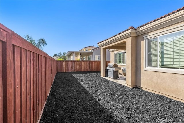fenced backyard featuring a patio area