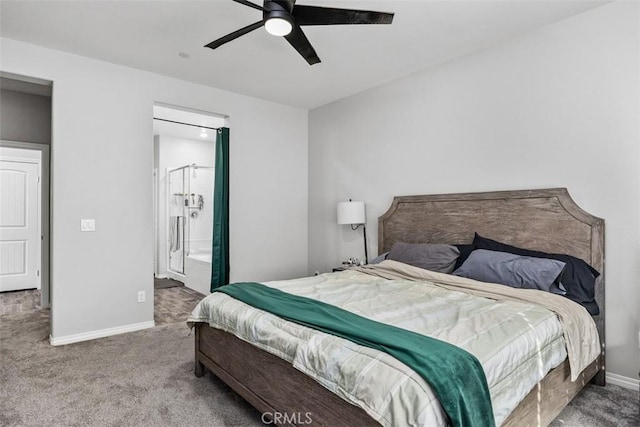 carpeted bedroom featuring baseboards, a ceiling fan, and ensuite bath