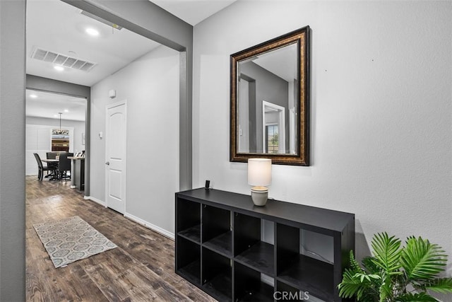 hallway with dark wood-style flooring, baseboards, and recessed lighting