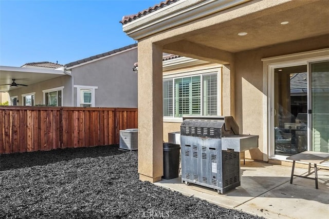 view of patio / terrace featuring fence, a ceiling fan, and central air condition unit