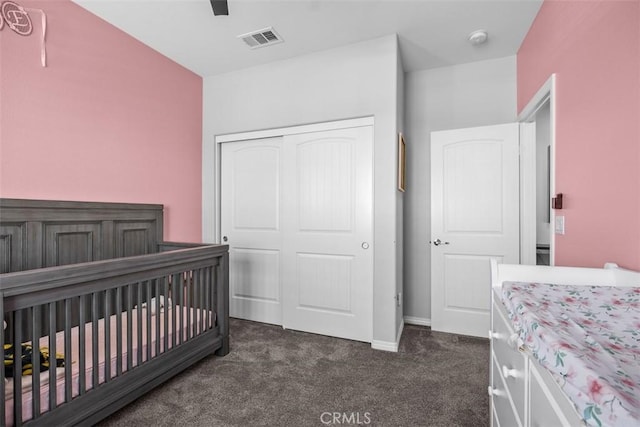 bedroom with dark colored carpet, a closet, baseboards, and ceiling fan