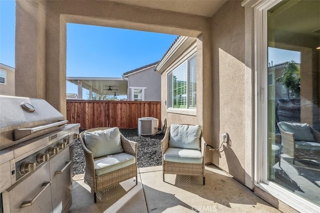 balcony featuring central AC, a patio area, and exterior kitchen